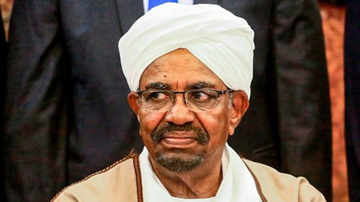 Sudan's President Omar al-Bashir poses for a group photo with members of his new 20-member cabinet as they take oath at the presidential palace